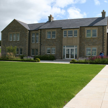 Large stone house completed in Mountcharles Sandstone Machined Rubble and architectural sandstone surrounds, quoins, steps and more. 