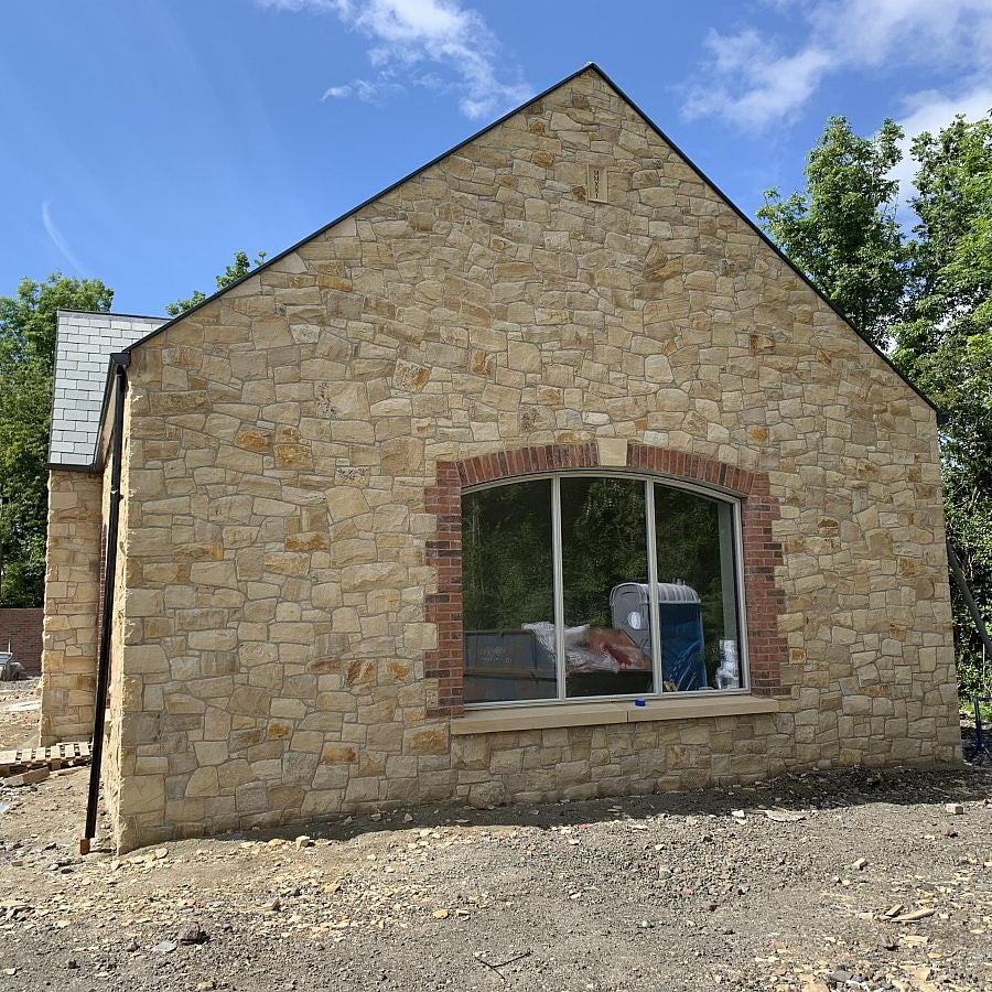 stone house completed in Mountcharles Sandstone Machined Rubble and architectural sandstone sill. 