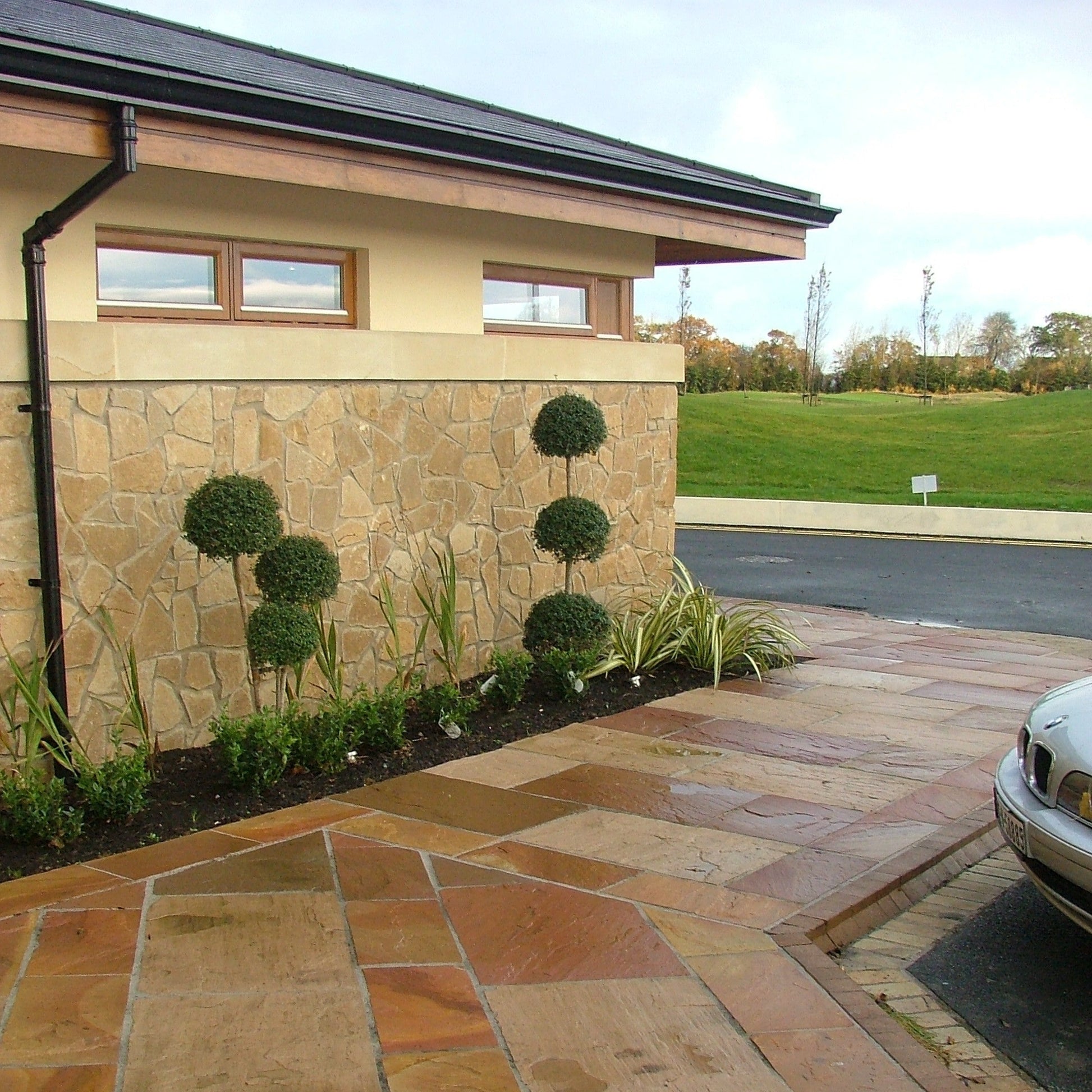 Golf club with decorative stone walling in Mountcharles Sandstone Machined Rubble. 