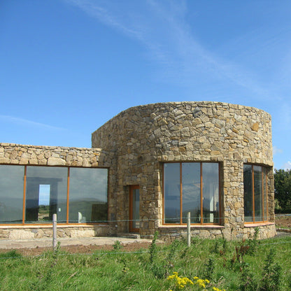Stone building completed in Mountcharles Sandstone Machined Rubble. 
