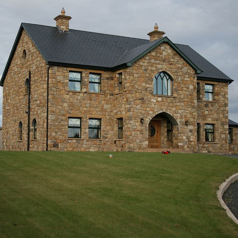 Two storey stone house completed in Mountcharles Sandstone Machined Rubble. 