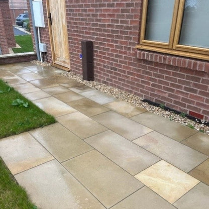 Mountcharles Sandstone Paving at the rear of a red brick house. 