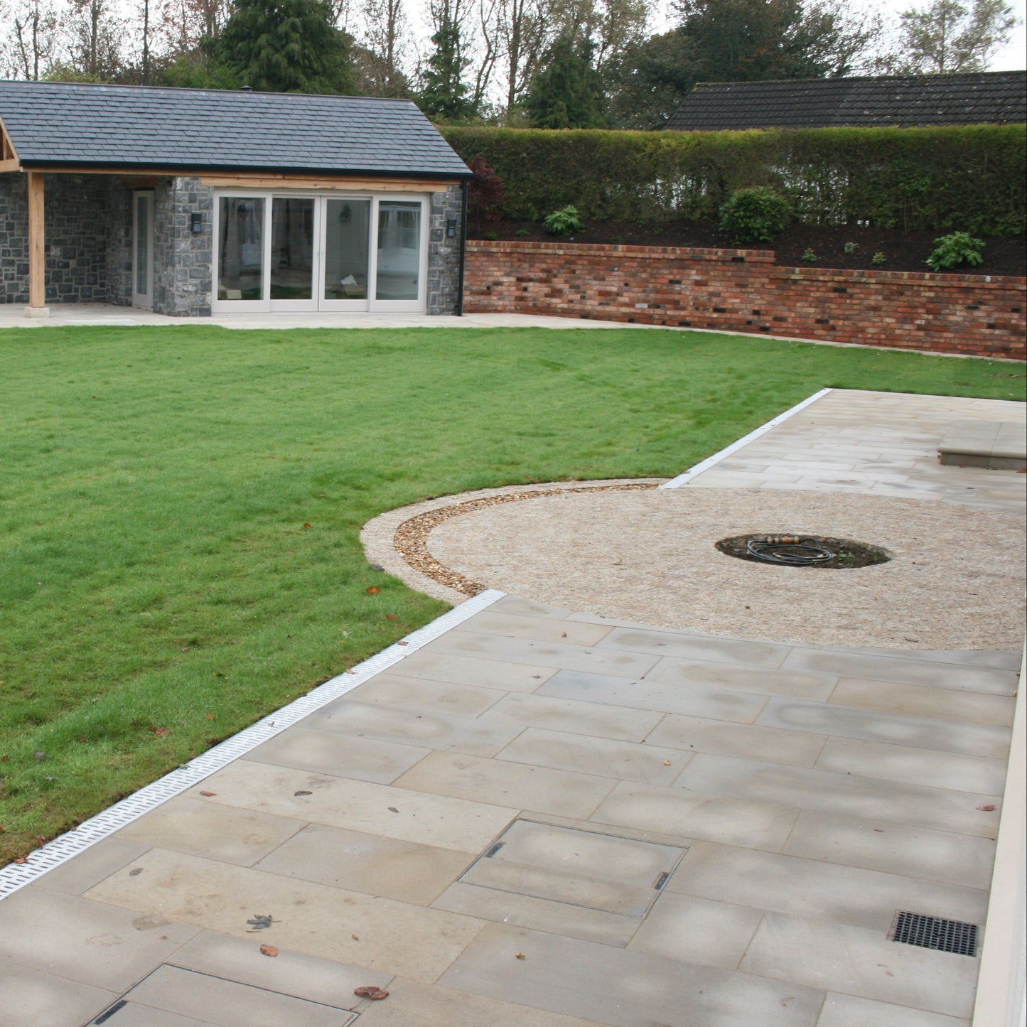 Patio area completed using Mountcharles Sandstone Paving. Pathway leading to outdoor garden room. 
