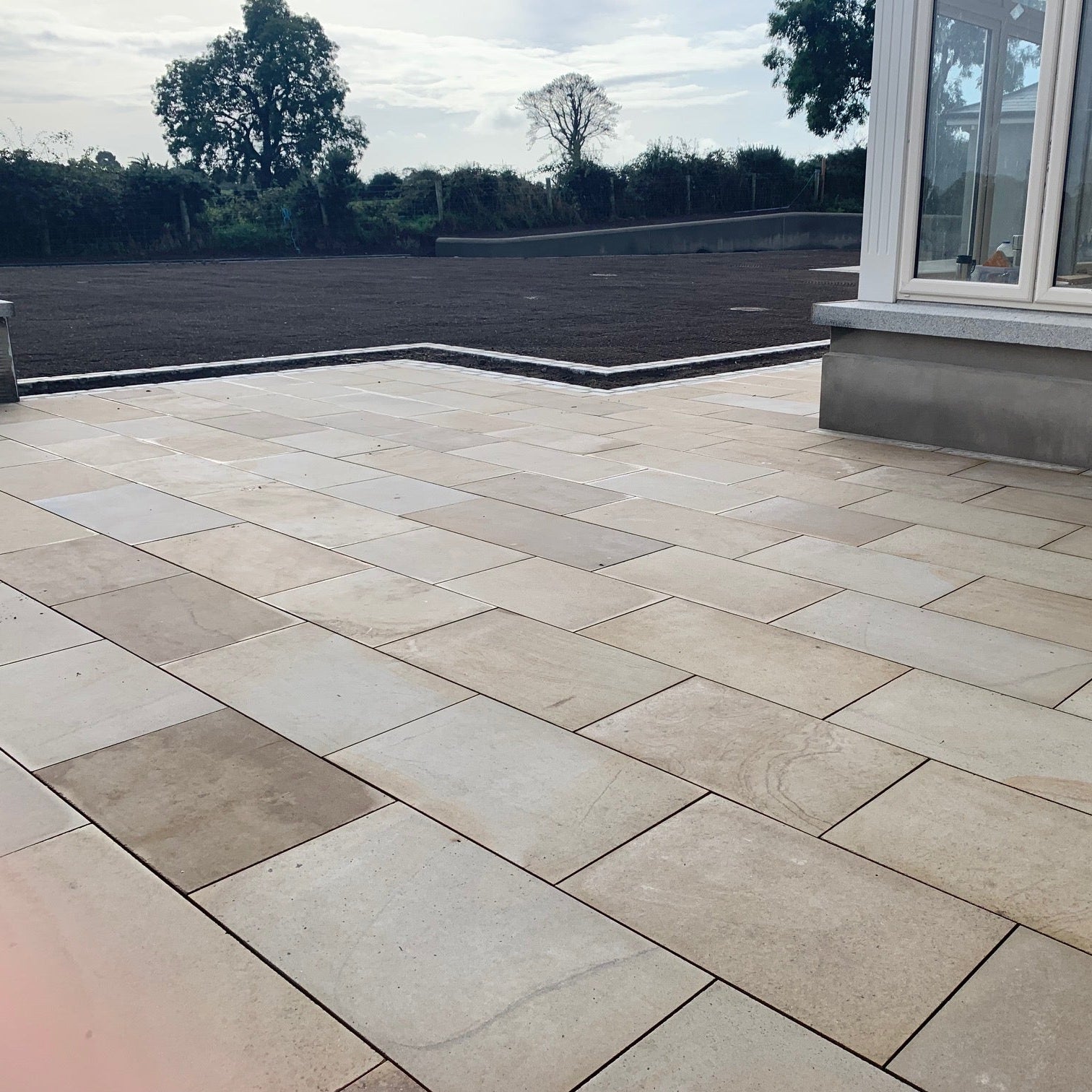 Patio area of a new build finished using Mountcharles Sandstone Paving Slabs. 