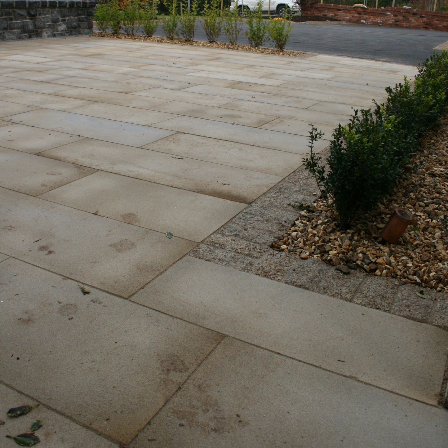 Patio area completed using Mountcharles Sandstone with a Silver Granite cobble border. 