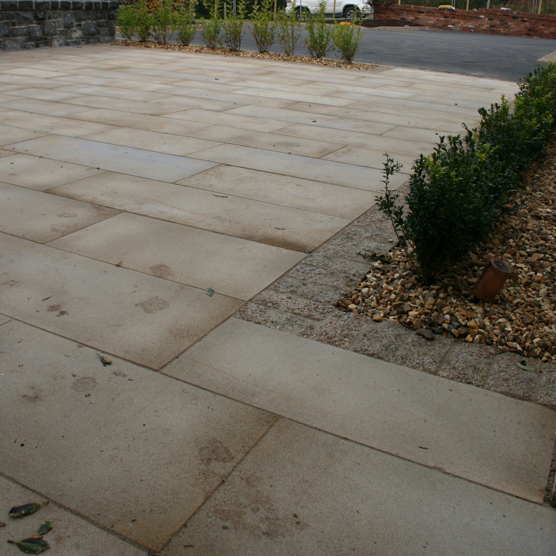 Patio area completed using Mountcharles Sandstone with a Silver Granite cobble border. 