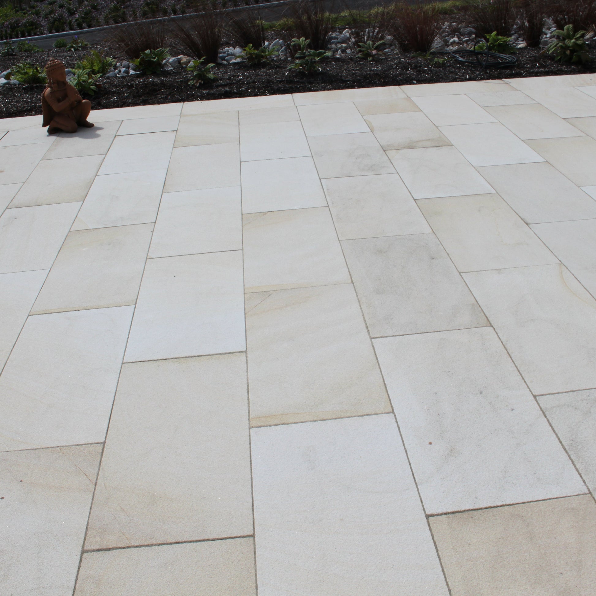 Close up of Mountcharles Sandstone Paving Slabs on a large patio area. 