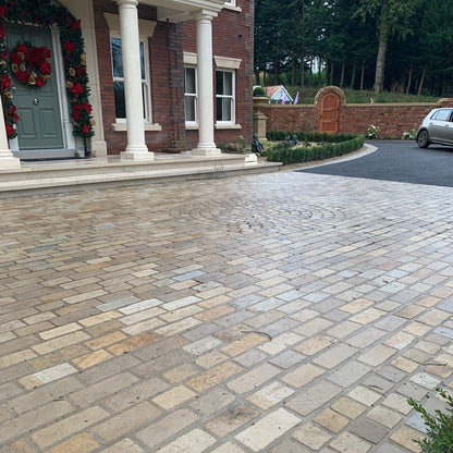 Paved driveway using Mountcharles Sandstone Paving Setts leading to a house with decorative wreaths on the door.
