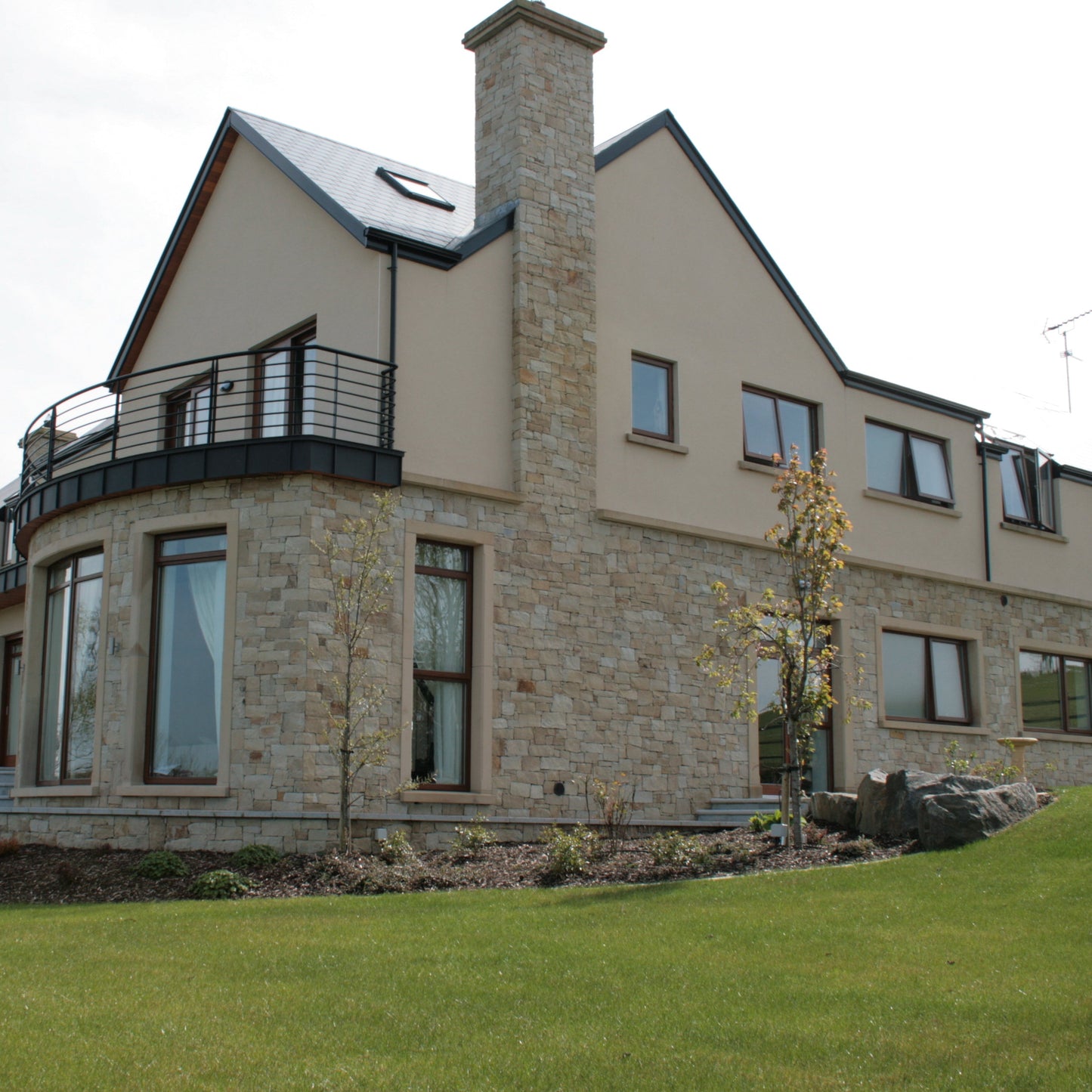 Large two storey house partially cladded in Mountcharles Sandstone Stoneer Cladding. 