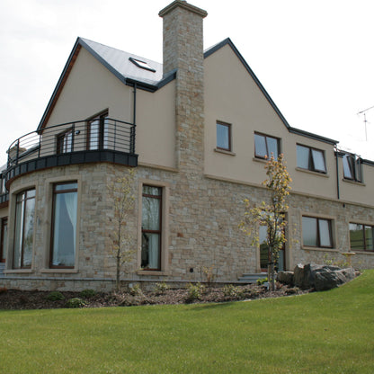 Large two storey house partially cladded in Mountcharles Sandstone Stoneer Cladding. 
