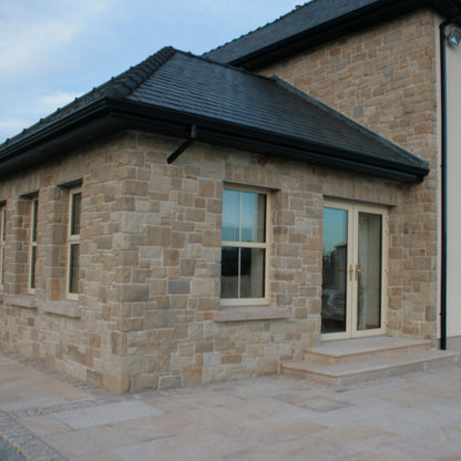 Mountcharles Sandstone Stoneer Cladding installed on a sunroom and wall façade. 