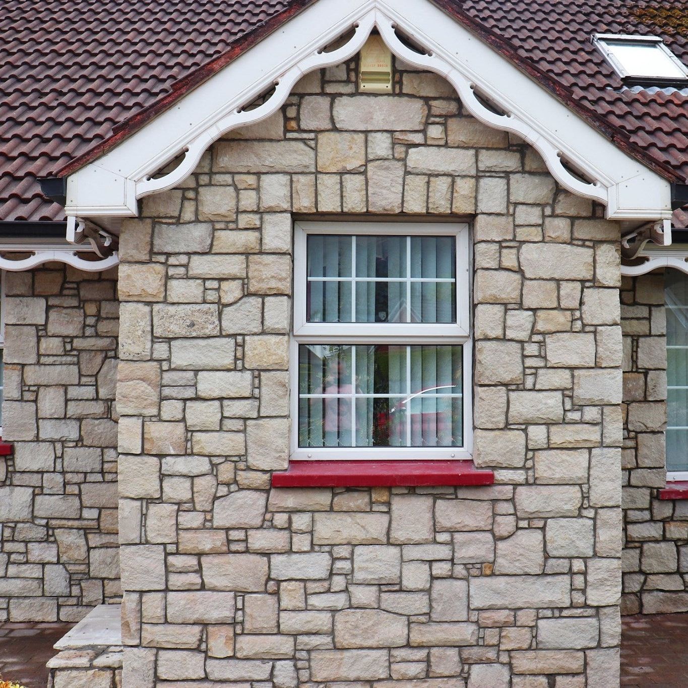 Cottage style house cladded in Mountcharles Sandstone Stoneer Cladding. 