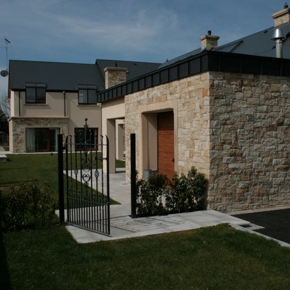 Garage featuring Mountcharles Sandstone Stoneer Cladding with well maintained garden. 