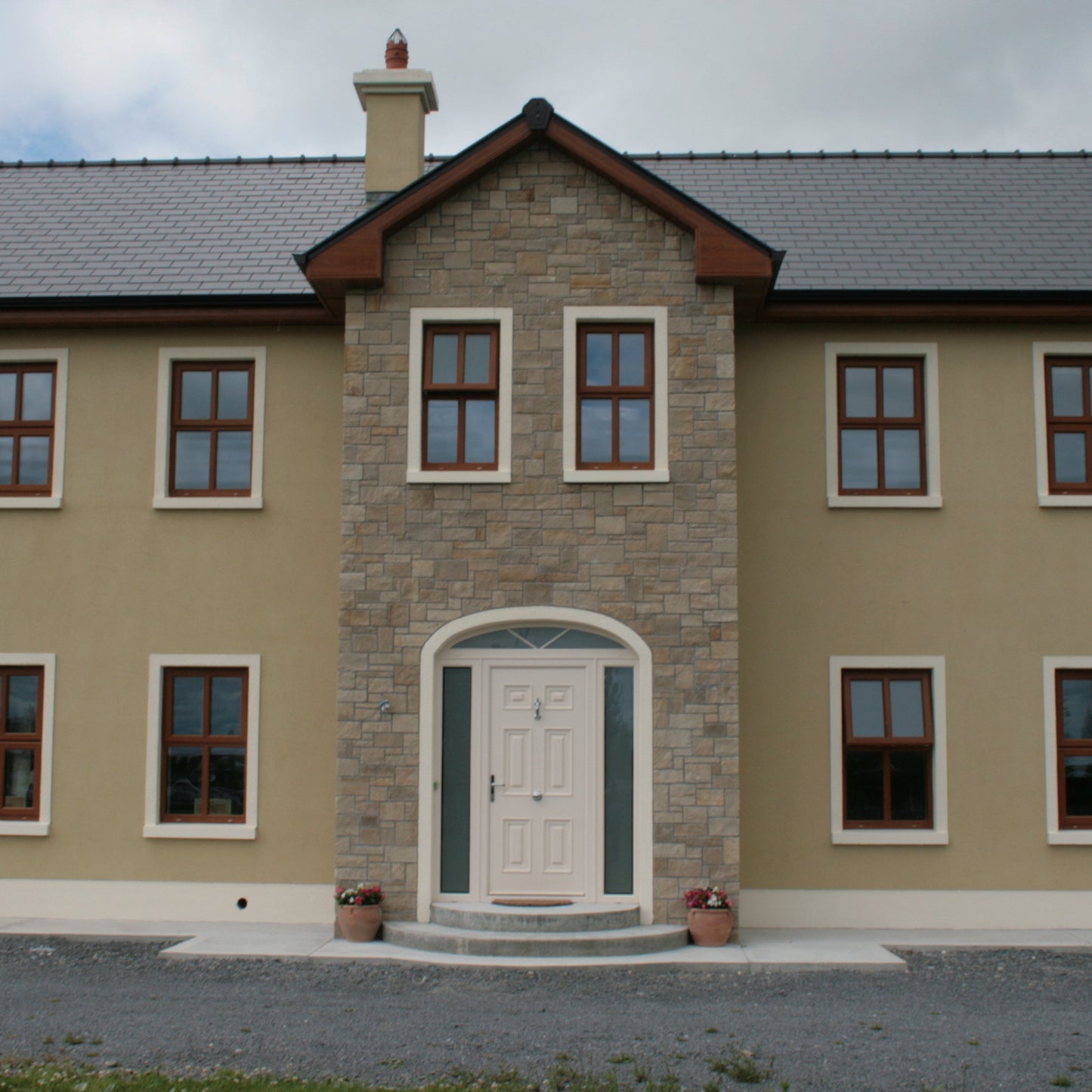 Large two storey house with stone façade in Mountcharles Sandstone Stoneer Cladding. 