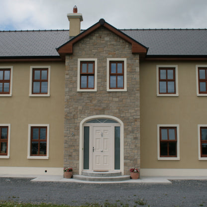 Large two storey house with stone façade in Mountcharles Sandstone Stoneer Cladding. 