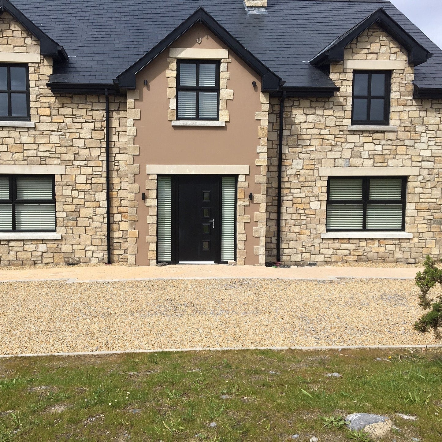Two storey house with Mountcharles Sandstone Stoneer Cladding. 