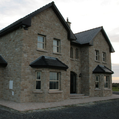 Large stone house completed using Mountcharles Sandstone Stoneer Cladding. 