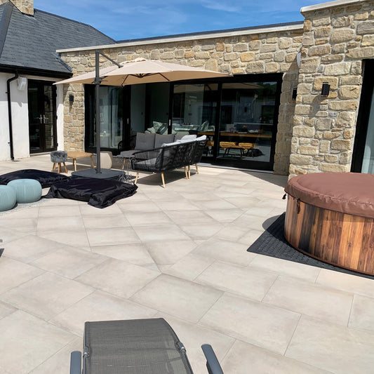 Modern new build with stone façade in Mountcharles Sandstone Tumbled walling stone. Patio area and hot tub in the foreground. 
