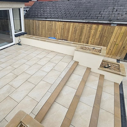 Patio planter wall completed with bespoke flat Mountcharles Sandstone Wall Capping. 