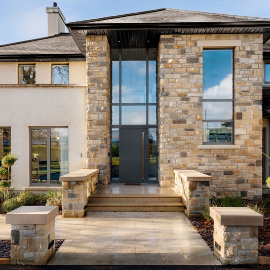 Modern new build with entrance walls completed with bespoke flat Sandstone Wall Capping. 