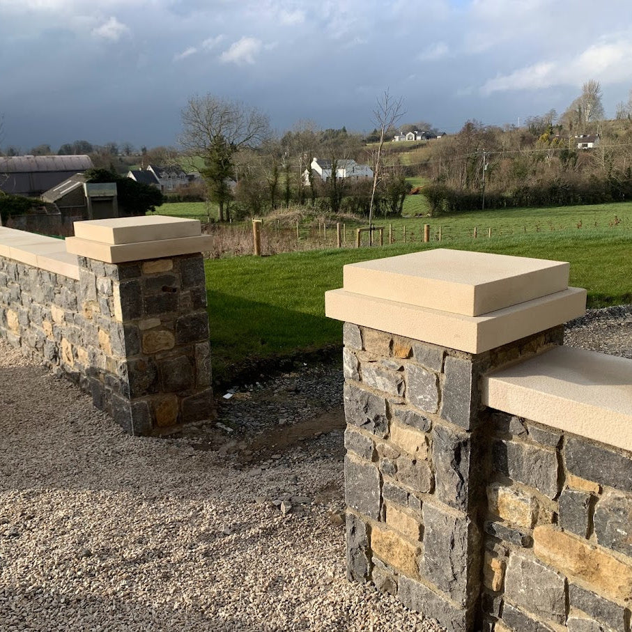 Stone garden walls completed with bespoke sandstone wall and pillar caps. 
