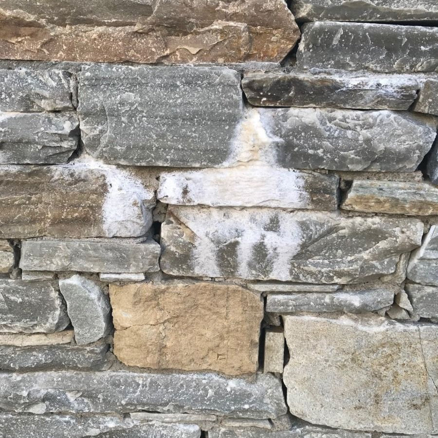 A stone wall showing a patch of Efflorescence. 