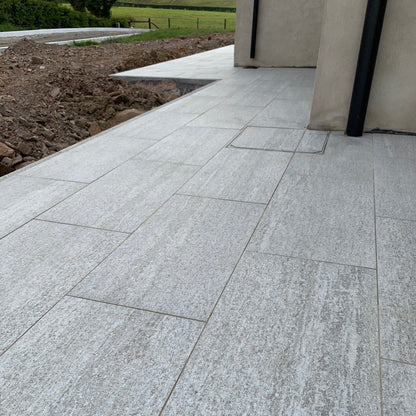 Close up of patio under construction using Pietra Di Bagnolo Porcelain Paving.