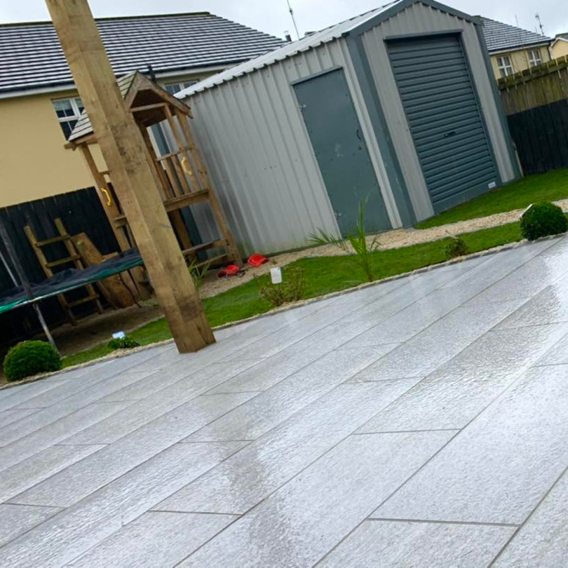 Patio area with shed. Paving is Pietra di Bagnolo porcelain tiles. 