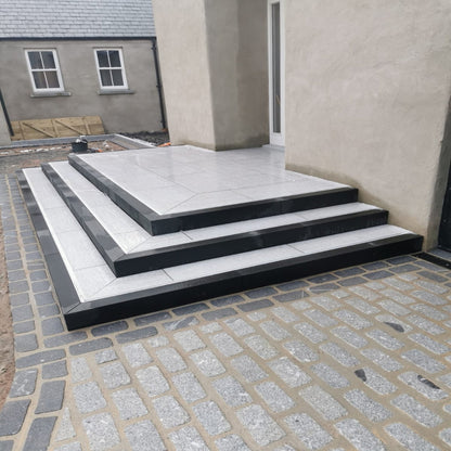Steps leading up to house entrance completed using Pietra Di Bagnolo Porcelain Tiles and Black Granite Kerbing. 