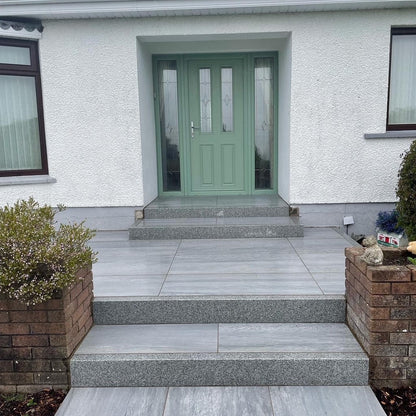 Steps leading up to a house entrance. Paving is Pietra di Vals porcelain tiles. 
