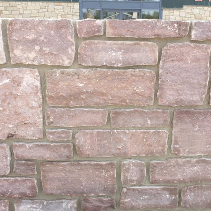 Display wall at McMonagle Stone featuring Pink Sandstone Machined. 