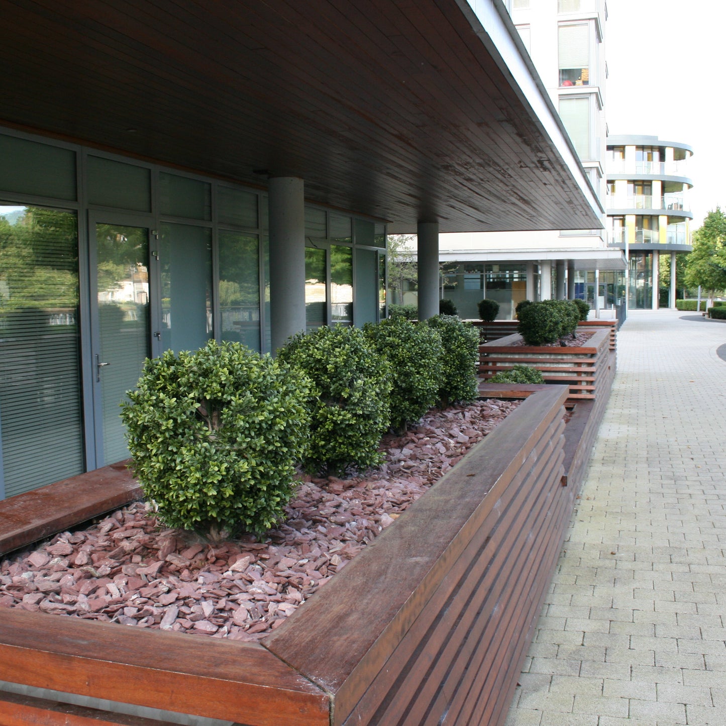 Decorative planters with Plum Slate Mulch filler outside a commercial building. 