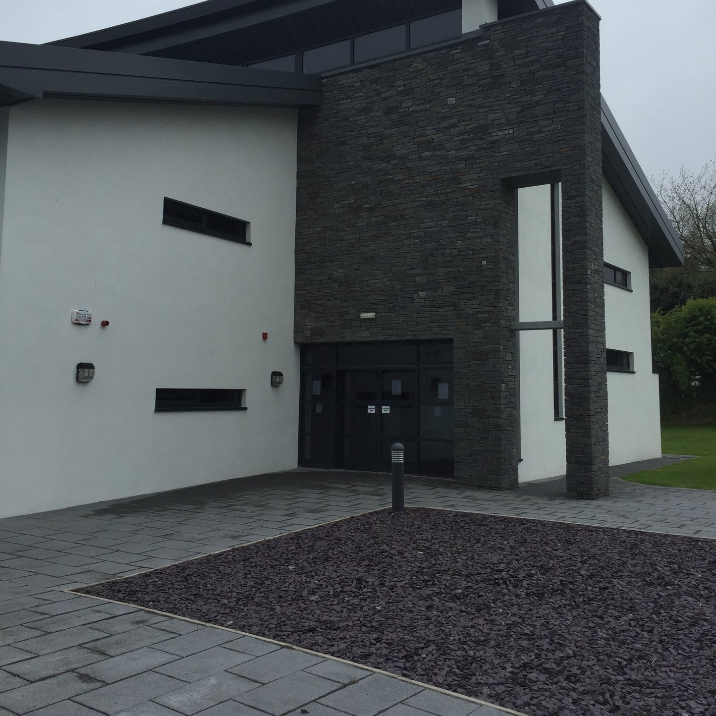 Commercial building with pathway and Plum Slate Mulch Chipping in a square design. 