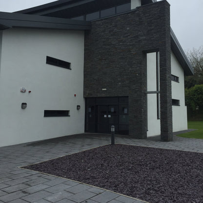 Commercial building with pathway and Plum Slate Mulch Chipping in a square design. 