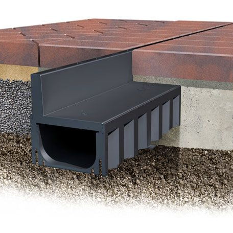 Installation artwork of a poly brick slot channel drain installed in pavement. 