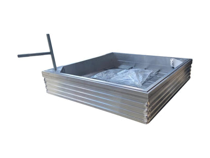 A recessed manhole cover with a metal frame and a clear plastic wrapping on top, designed to fit into a 300 x 300 mm space.