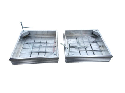 Two recessed manhole covers side by side. 
