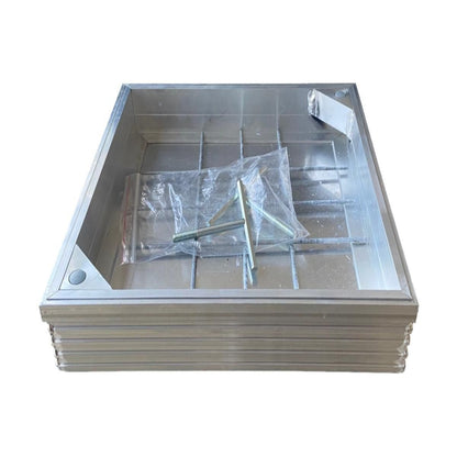 A recessed manhole cover with a metal frame and a clear plastic wrapping on top, designed to fit into a 300 x 300 mm space.