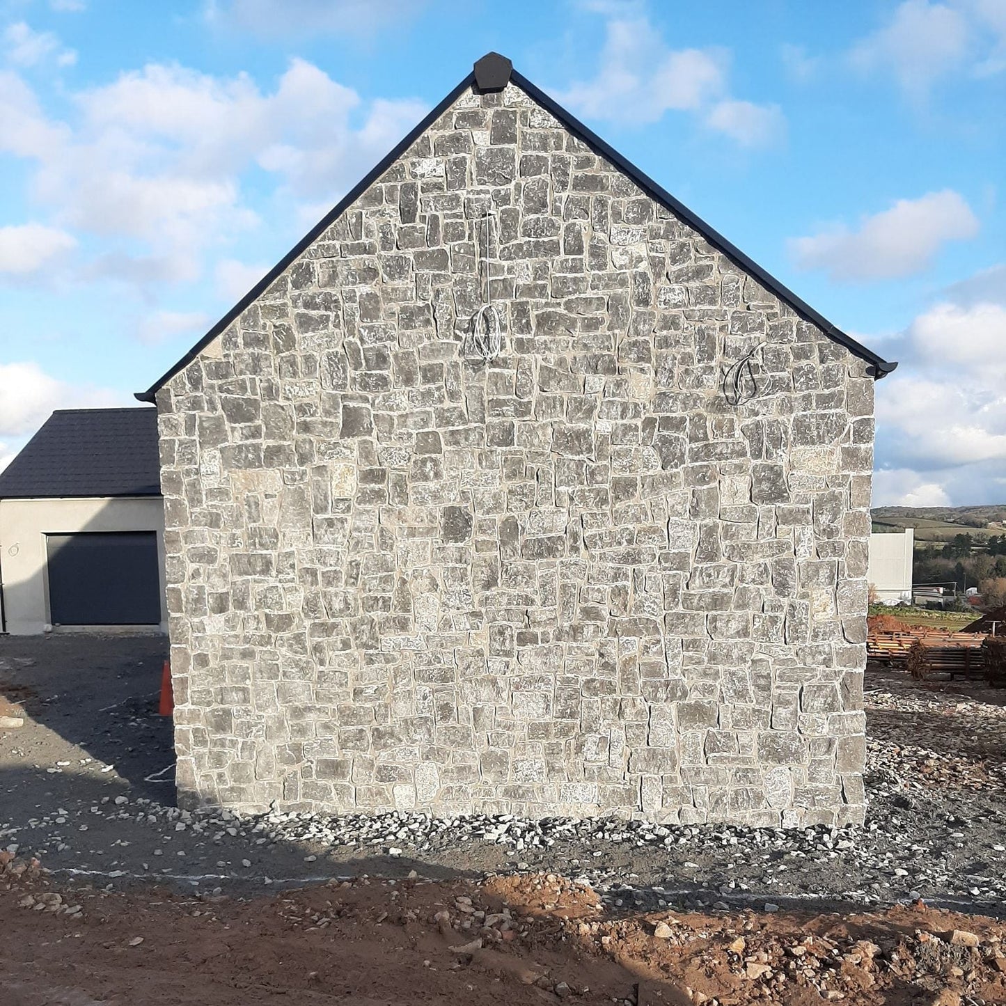Gable wall cladded in stone featuring Rustic Blue Limestone Stoneer Cladding.