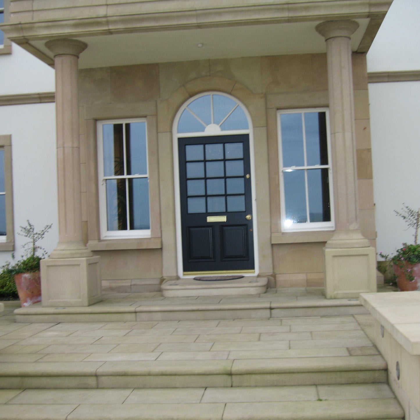 Sandstone Portico featuring bespoke sandstone door surround. 