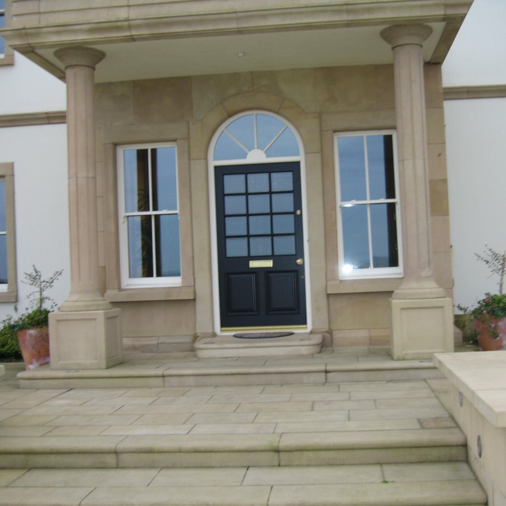 Sandstone Portico featuring bespoke sandstone door surround. 