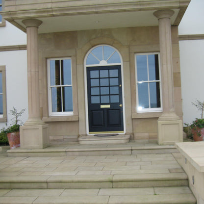 Sandstone Portico featuring bespoke sandstone door surround. 