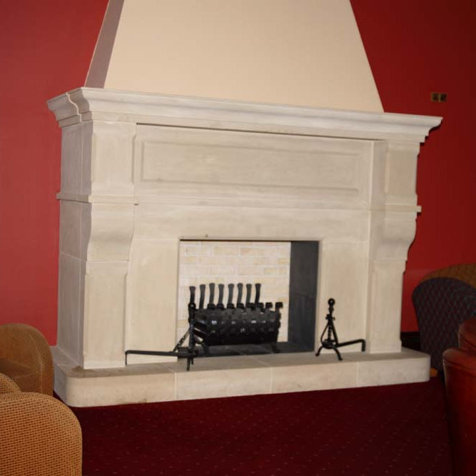 Large Architectural Sandstone Fireplace Surround and Hearth in a Hotel Lobby. 