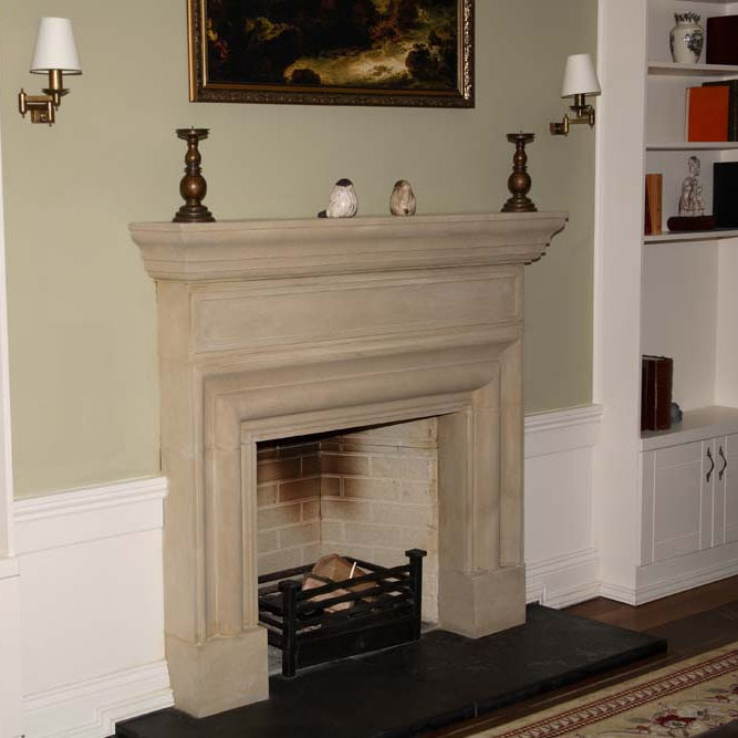 Traditional Sandstone Fireplace Surround with a Black Stone Hearth