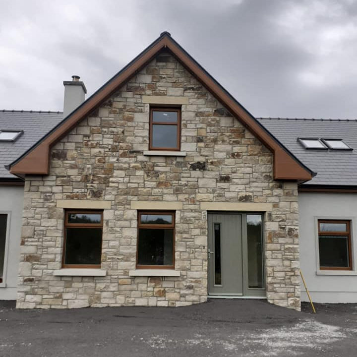 House with stone exterior featuring bespoke Sandstone Lintels. 