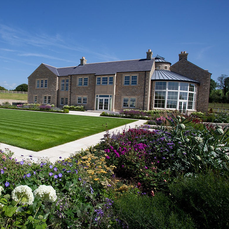Large stone house with bespoke sandstone quoins and window surrounds 
