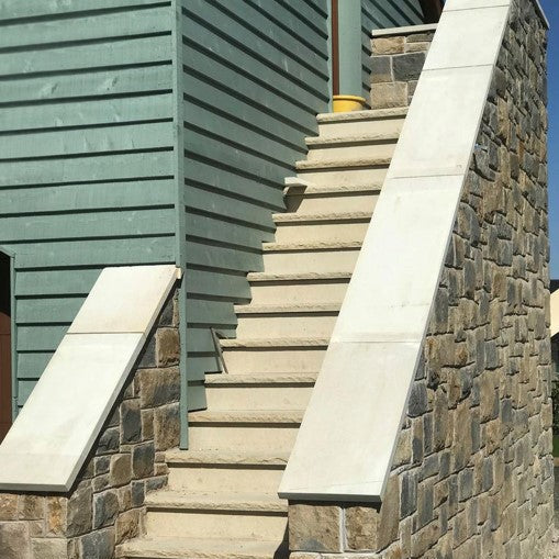 External stair walls completed using bespoke sandstone wall capping. 