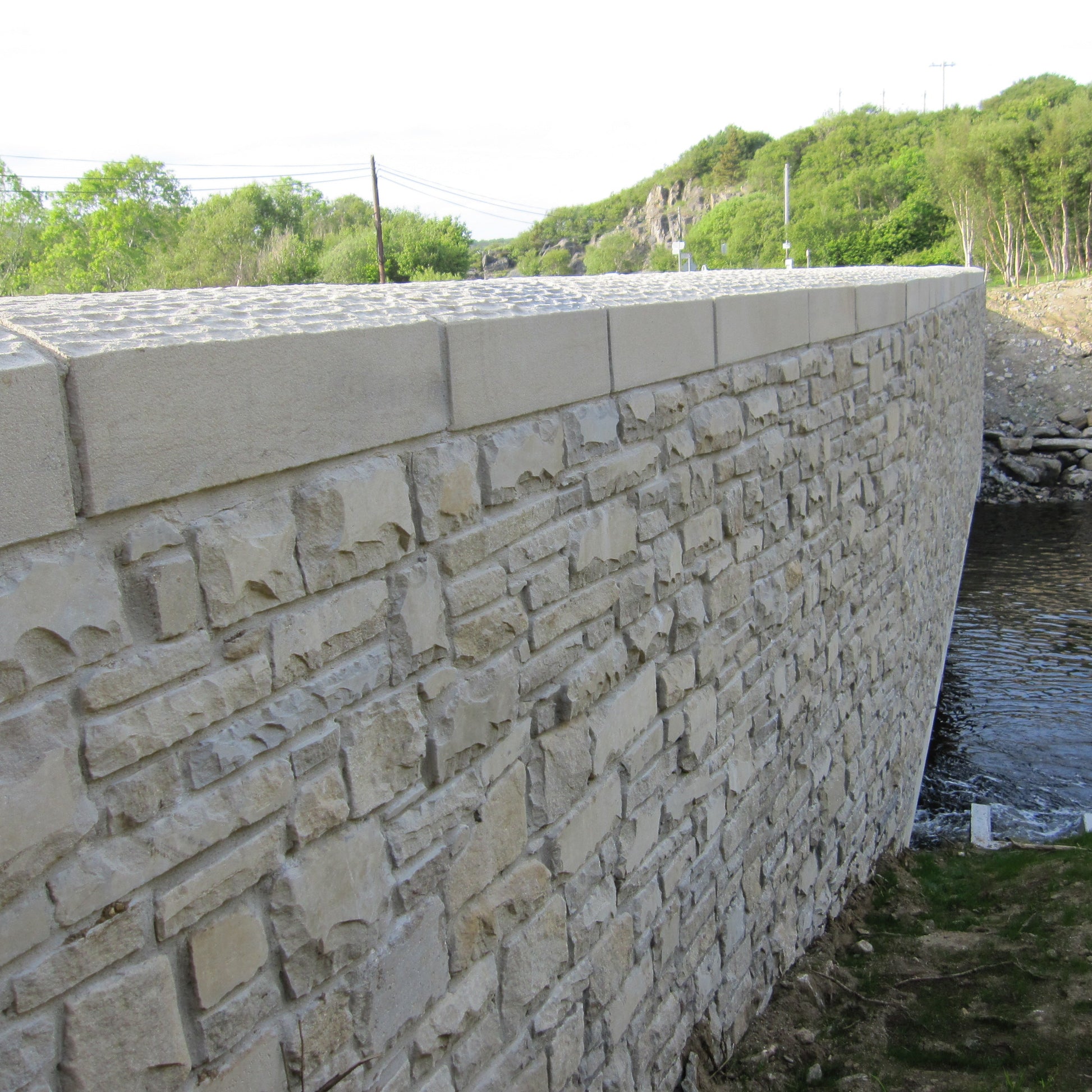Stone bridge with bespoke sandstone wall capping. 