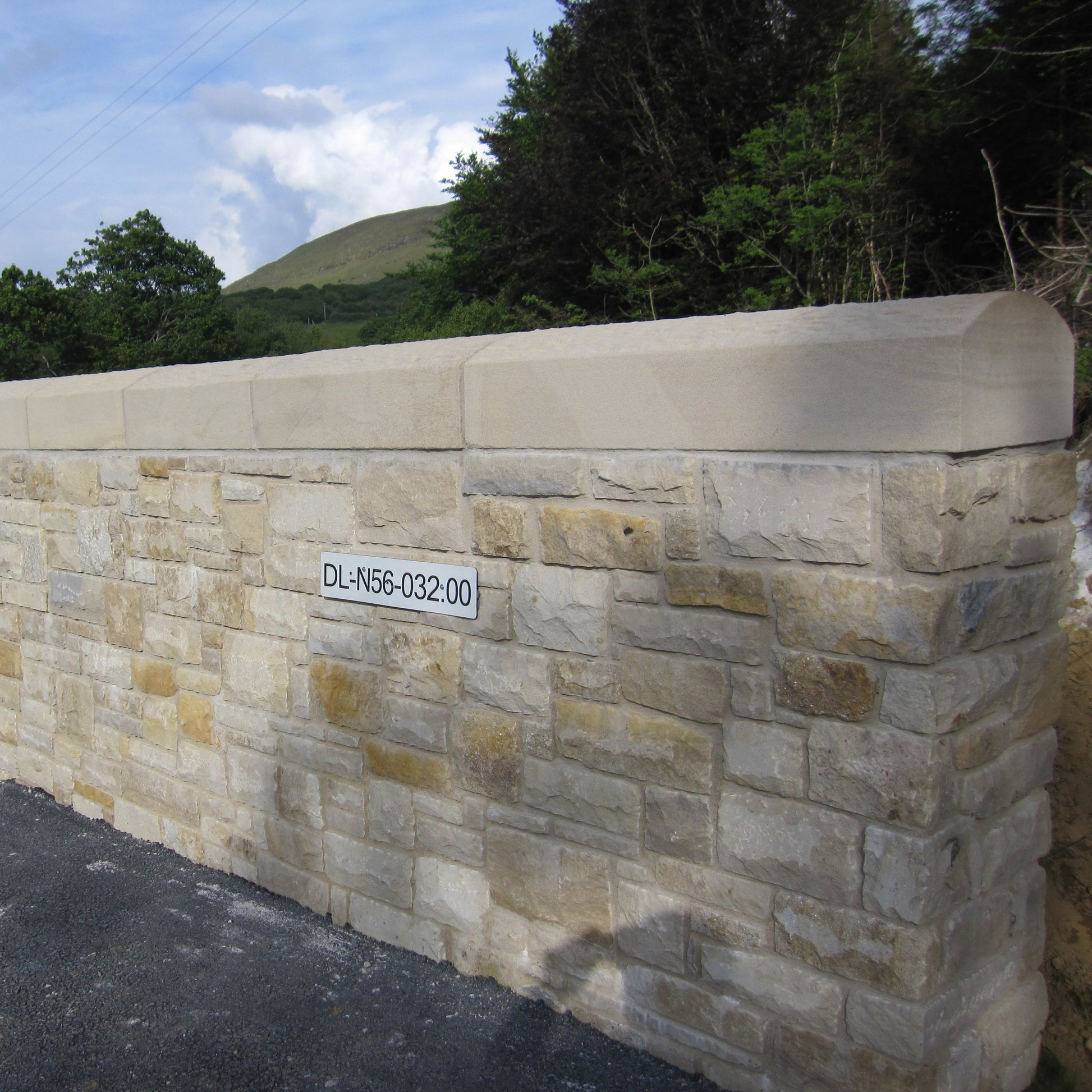 Roadside stone wall with bespoke sandstone wall capping. 
