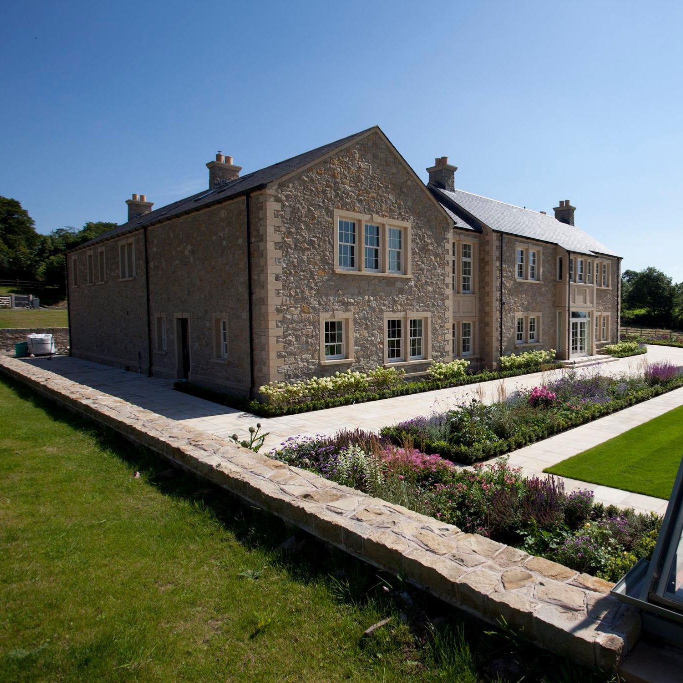 Large stone house with Sandstone Window Surrounds and well maintained patio and garden. 
